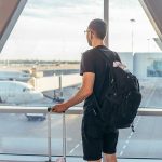 Airports Abandoned NATIONWIDE—Shutdown Chaos Freezes Travel! A traveler looking out of an airport window at parked airplanes