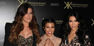 Three Kardashian sisters posing together at a fashion event