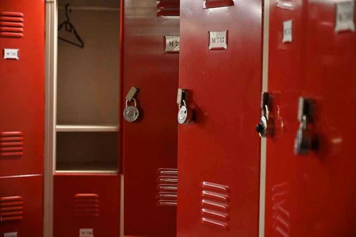 Red lockers with padlocks, one open with hanger.