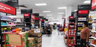 Interior of a grocery store with shelves filled with products and shoppers