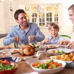 A family enjoying a dinner together at a table filled with food