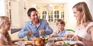 A family enjoying a dinner together at a table filled with food