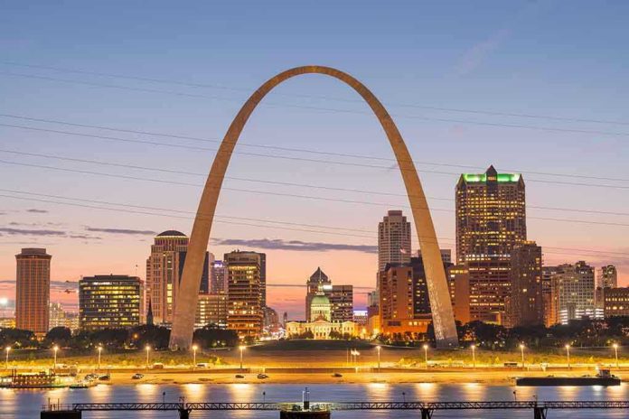 St. Louis Gateway Arch at sunset with cityscape.
