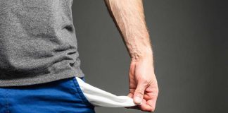 Person pulling out empty pocket from shorts.