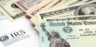 A tax refund check from the IRS alongside various denominations of cash