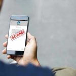 Scammers Invade Phones: Americans Left Helpless Person reading a scam message on a smartphone.