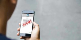 Person reading a scam message on a smartphone.