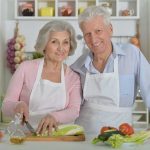 Elderly couple cooking together in the kitchen