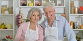 Elderly couple cooking together in the kitchen