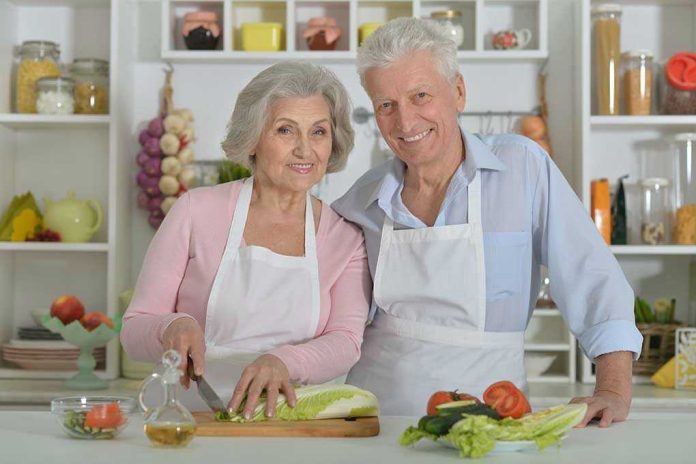 Elderly couple cooking together in the kitchen