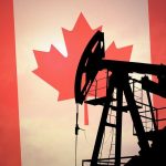 Silhouette of an oil pump jack against a Canadian flag background