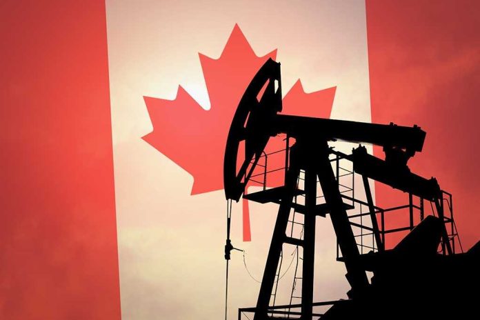 Silhouette of an oil pump jack against a Canadian flag background