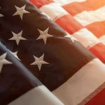 19 Million Clicks: Kid Rock’s Viral Christian Anthem Close-up of American flag with sunlit background.