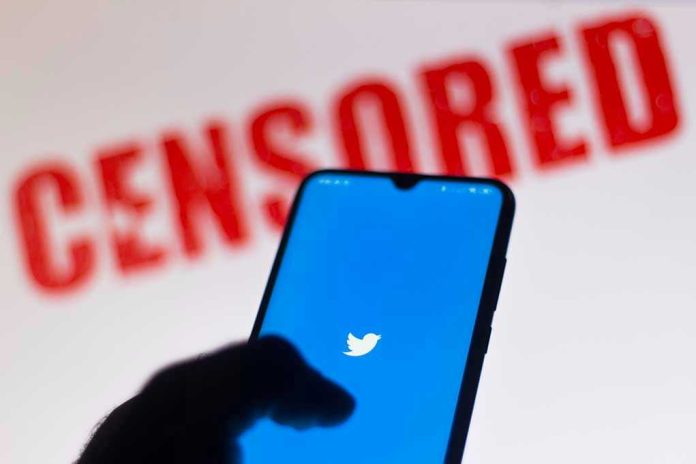 1756782404 Phone displaying Twitter app with CENSORED in background.