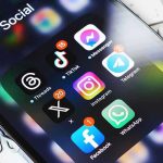 Smartphone showing social media app icons in a folder.