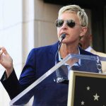 BUSTED: Ellen Secretly Buys California Estate A woman in sunglasses speaking at a podium during an outdoor event