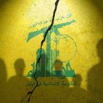 Hezbollah flag with shadows of people and a crack.