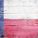 Texas flag displayed on a wooden background