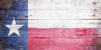 Texas flag displayed on a wooden background