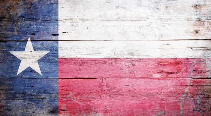 Texas flag displayed on a wooden background