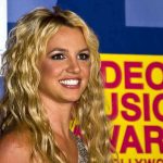 A smiling woman with blonde hair at a music awards event