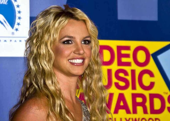 A smiling woman with blonde hair at a music awards event