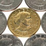 A collection of coins featuring a gold coin surrounded by silver coins