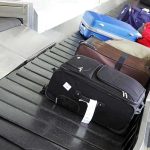 Various suitcases on an airport luggage carousel