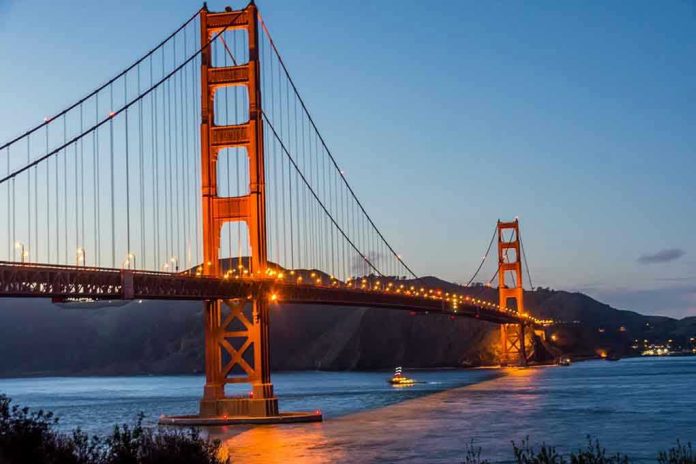 Golden Gate Bridge at dusk with lights on.