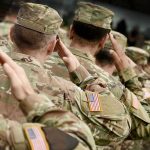 Trump RAIDS $8 Billion — Troops Paid, Innovation Gutted Soldiers in camouflage uniforms saluting in formation outdoors
