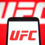 UFC Fighter BURNS $700,000 Every Single Month UFC logo on phone screen and background.