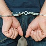 ASSASSINATION Plot Uncovered—FBI Raids Pennsylvania Home Person in handcuffs behind their back.