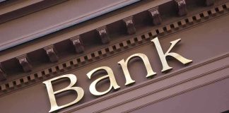Trump’s Banking Order Sparks IMMIGRATION FIRESTORM — What’s Next? Gold bank sign on building facade