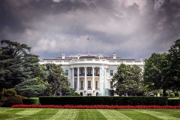562939351 White House front view with dark clouds above.