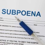 Georgia Senate Targets Stacey Abrams—Campaign Violations Exposed A subpoena document with a blue pen resting on it