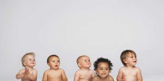 Future Crisis: Population Plunge Threatens Nations Five diverse babies sitting on a neutral background, displaying playful expressions