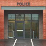 Receipt Exposes Chilling Murder Plot Entrance of a modern police station with brick facade