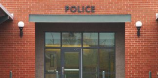 Receipt Exposes Chilling Murder Plot Entrance of a modern police station with brick facade