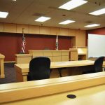 HOLLYWOOD SHOCKER: Actor’s Violent Rampage Interior view of an empty courtroom with wooden furniture and American flags