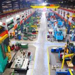Aerial view of a large industrial workshop filled with various machinery and equipment