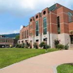Millionaire’s SHOCK Move Wipes Student Debts Modern educational building on a college campus with landscaped grounds