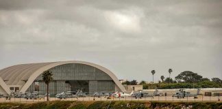 Iranian Strike Shuts Kuwait’s Main Airport Aircraft hangar with helicopters near the beach.