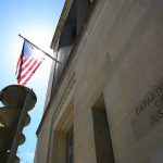ISIS Drone Cash Plot—Ex-Navy Tied In? American flag at Department of Justice building exterior.