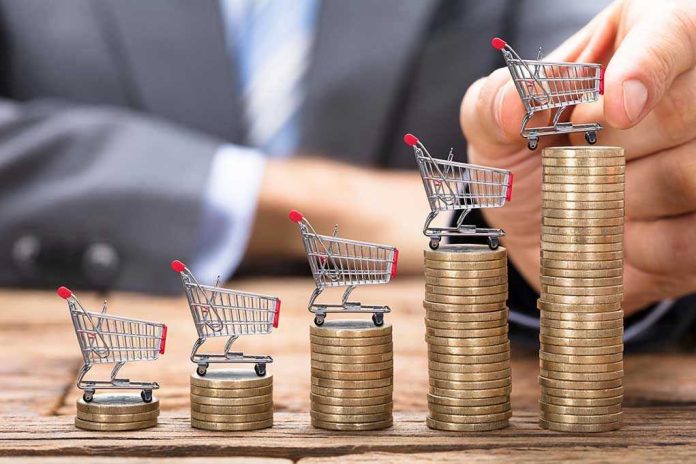 703848340 Mini shopping carts on stacks of coins, business background.