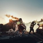 Emergency responders at an overturned, smoking car on a roadway