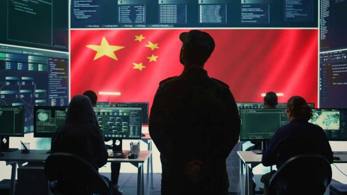 2482142301 Military personnel in control room, Chinese flag displayed.