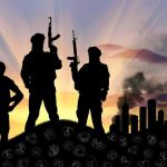 DOJ Drops Explosive Crypto-Terror Case Three armed silhouettes near a smoky city skyline.