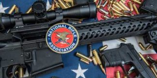 Fireworks Mask July 4 Gun Push A rifle and handgun surrounded by ammunition on an American flag