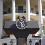 White House Showdown: Trump, Netanyahu Tuesday Presidential podium with seal in front of white-columned building