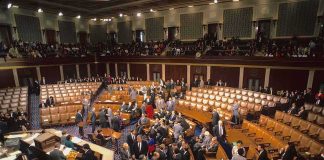 Intelligence Shake-Up: Clayton Takes Command Legislative chamber with members gathering on the floor